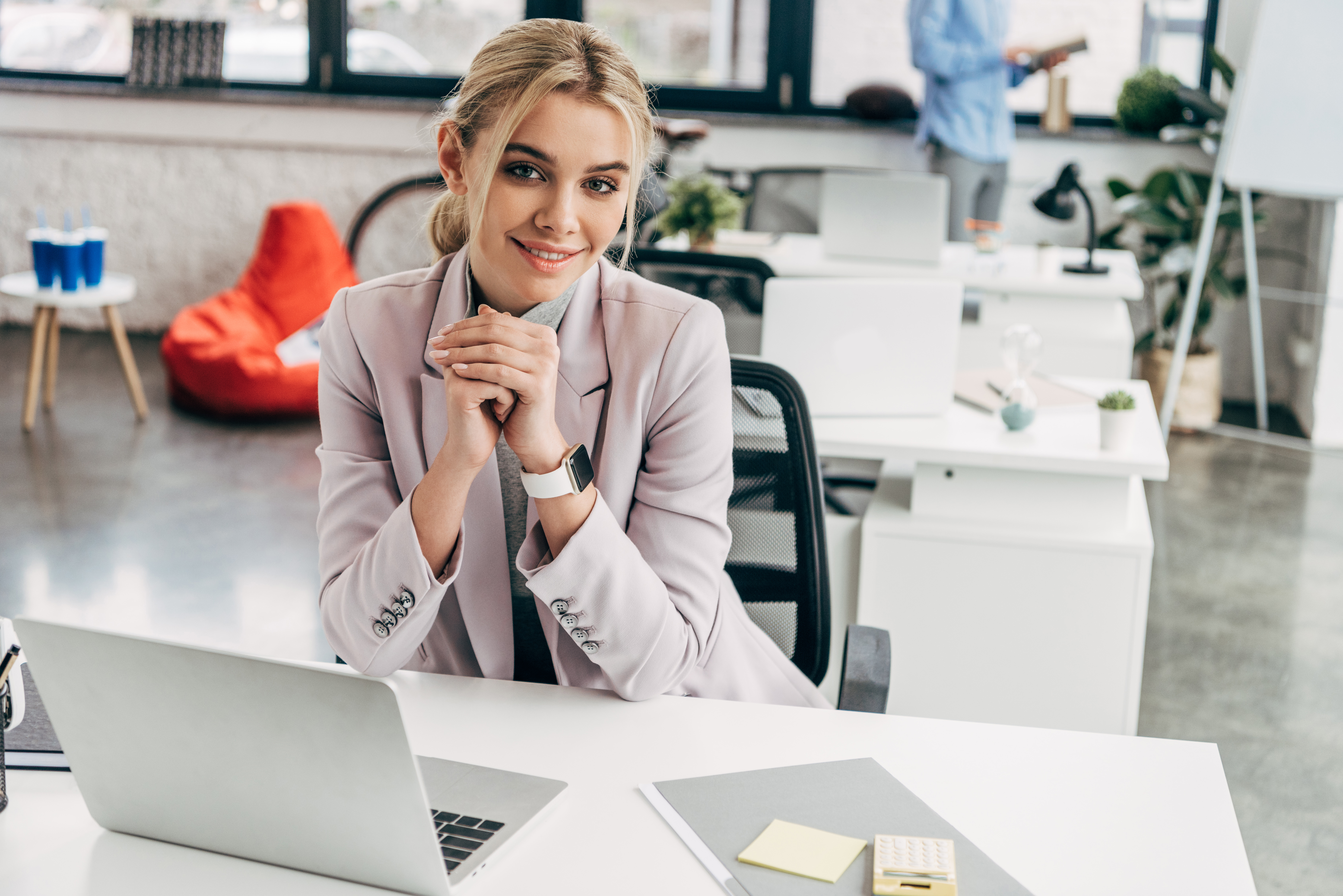 Wealth manager smiling at her desk